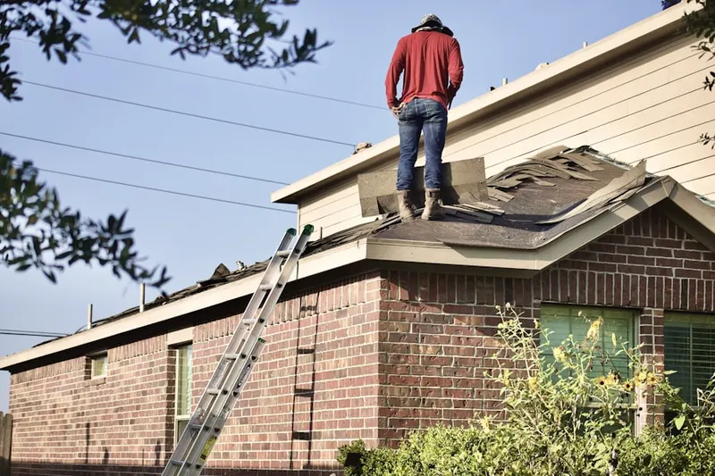 Professional roofer working on a residential roof in Albion Place